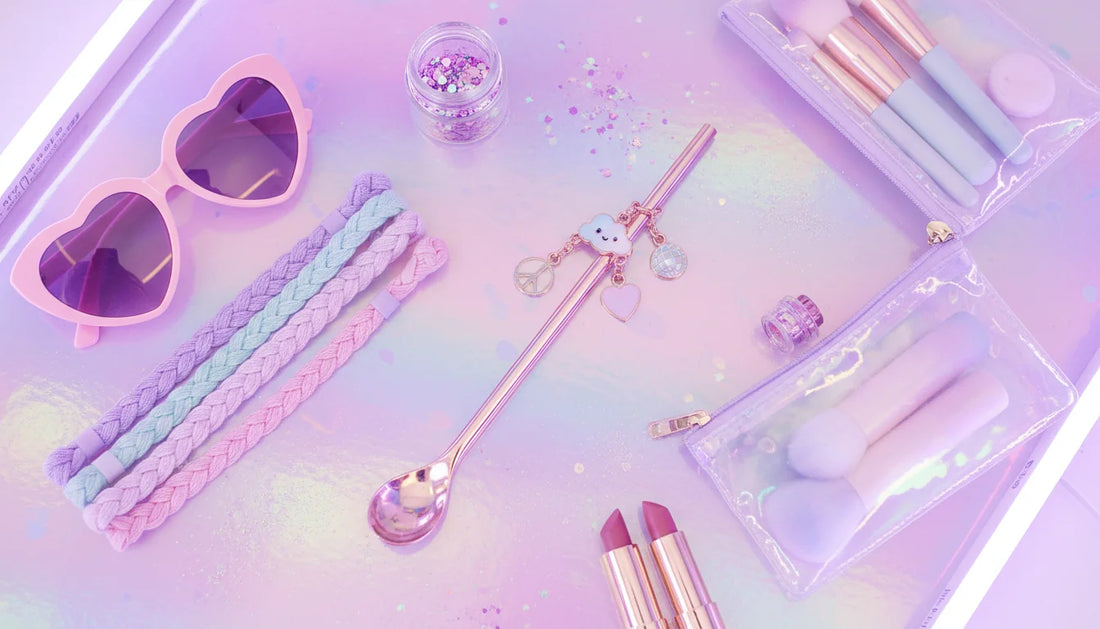 Pastel rave flatlay featuring a powder bump straw accessory with charms on a holographic background