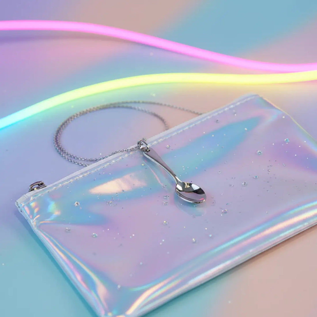 Cute micro spoon necklace pendant on a chain with pastel ravecore lighting