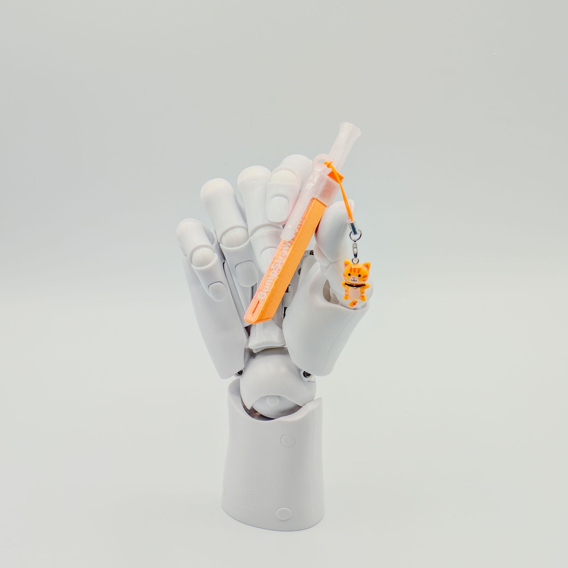 Orange bump straw powder spoon with tiger charm, perfect for measuring cacao or powders