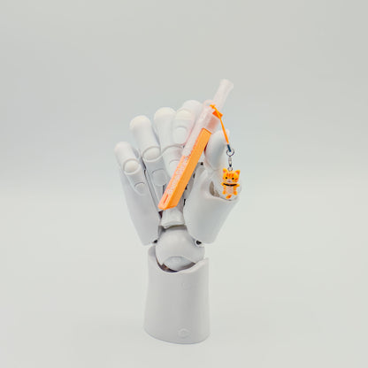 Orange bump straw powder spoon with tiger charm, perfect for measuring cacao or powders